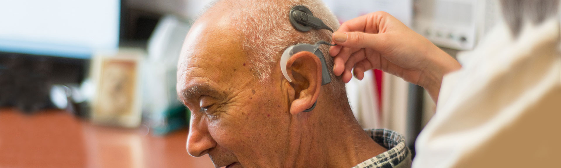 Image of male with Hearing aid device