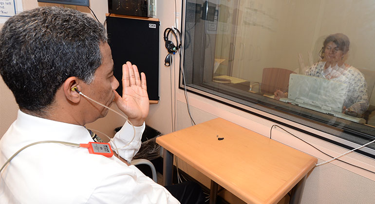 Image of doctor performing hearing test on patient