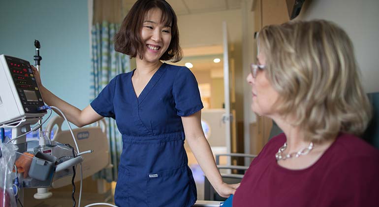 nurse with patient in exam room