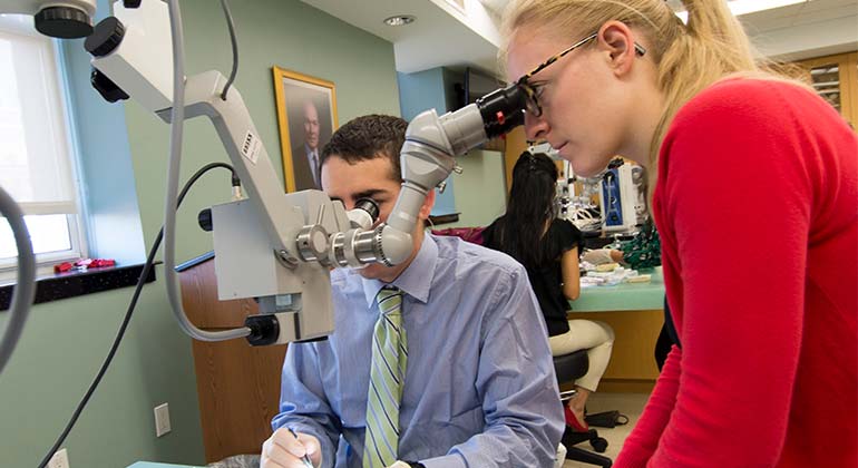 NYEE ophthalmology resident training on a surgical procedure