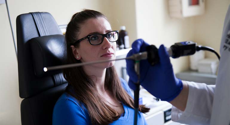 Rhinologist at NYEE examining female patient