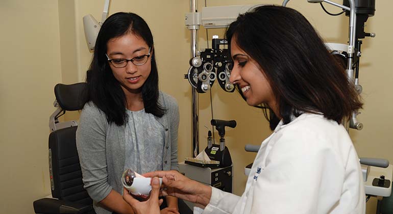 Doctor showing patient a model