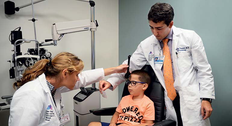 Doctors giving patient an eye exam