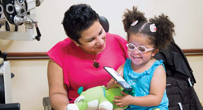 Pediatric patient and mother playing on a tablet