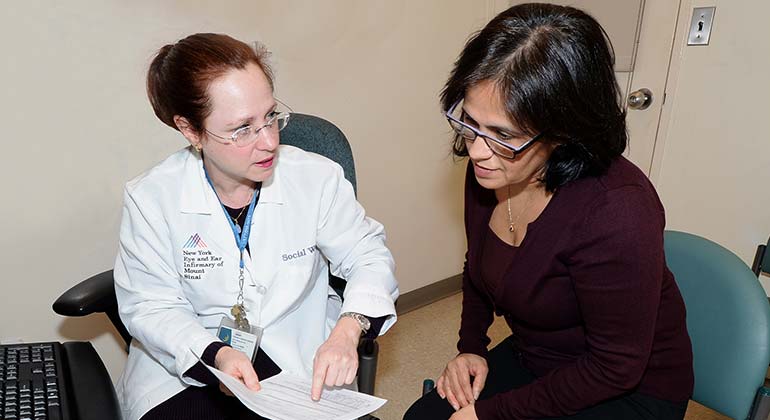 New York Eye and Ear Infirmary social working consulting with female patient