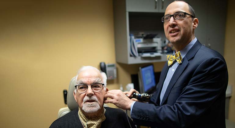 Image of doctor examining male patient