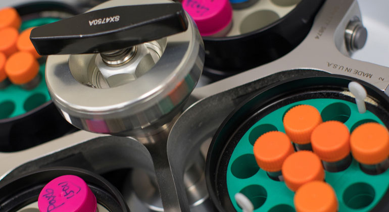 close-up of test tubes being processed